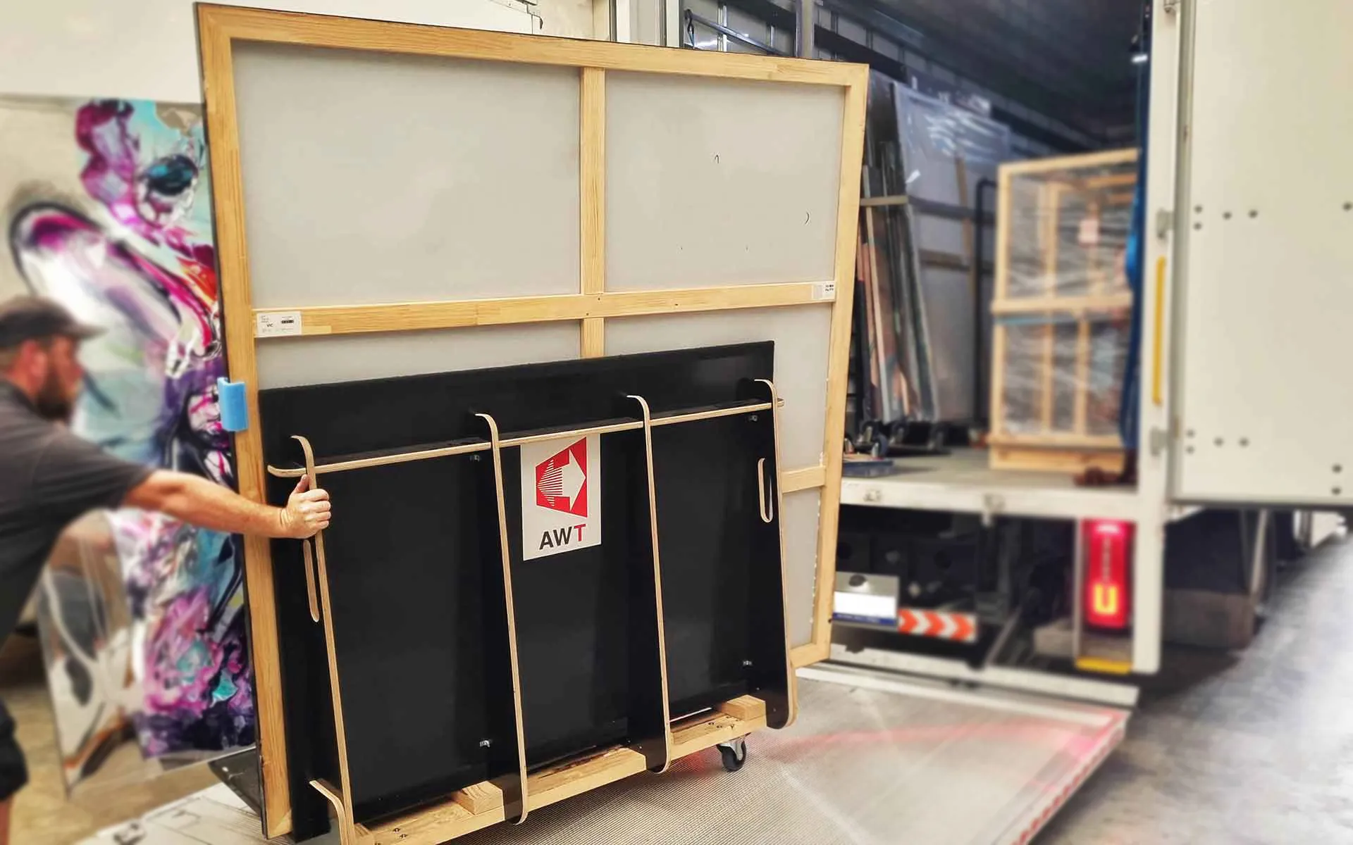 artwork transport warehouse with paintings and shipping crates stacked and ordered